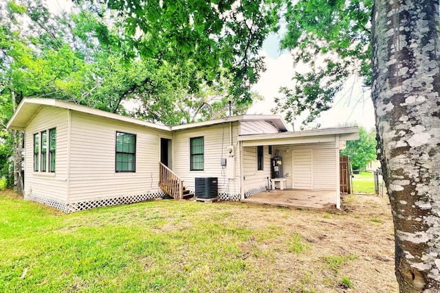 320 Azalea St, Lake Jackson, TX 77566 - rear view of property with central AC unit, a yard, and a patio