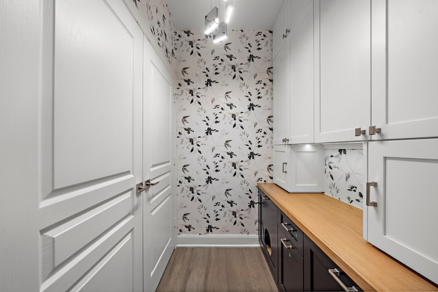 3333 Allen Pkwy Unit 1302, Houston, TX 77019 - laundry area featuring wallpapered walls, wood finished floors, and baseboards