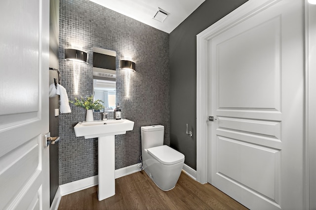 3333 Allen Pkwy Unit 1302, Houston, TX 77019 - half bathroom with toilet, wood finished floors, and baseboards