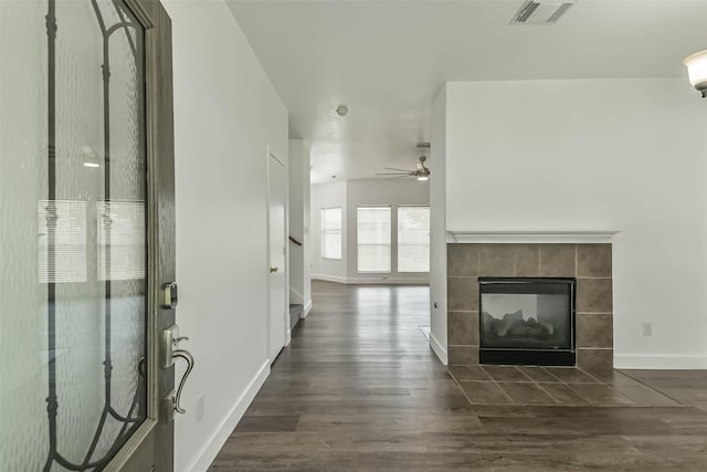 15503 Hickory Dale St, Cypress, TX 77429 - unfurnished living room featuring ceiling fan, baseboards, dark wood-style flooring, and a tiled fireplace