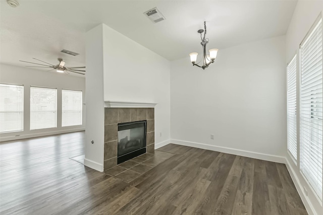 15503 Hickory Dale St, Cypress, TX 77429 - unfurnished living room featuring dark wood-style floors, a chandelier, a ceiling fan, and a tiled fireplace