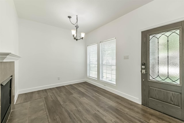 15503 Hickory Dale St, Cypress, TX 77429 - foyer with a chandelier, dark wood-style flooring, baseboards, and a fireplace
