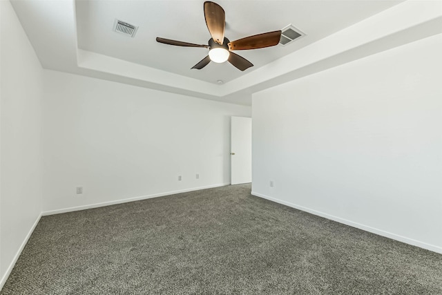 15503 Hickory Dale St, Cypress, TX 77429 - spare room with a raised ceiling, ceiling fan, dark colored carpet, and baseboards