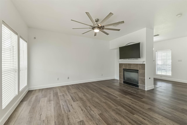 15503 Hickory Dale St, Cypress, TX 77429 - unfurnished living room with a ceiling fan, a tile fireplace, dark wood finished floors, and baseboards