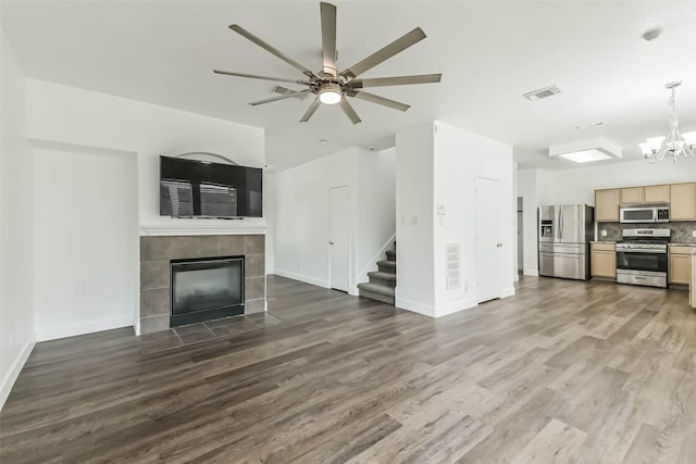 15503 Hickory Dale St, Cypress, TX 77429 - unfurnished living room featuring a tiled fireplace, stairs, wood finished floors, and baseboards