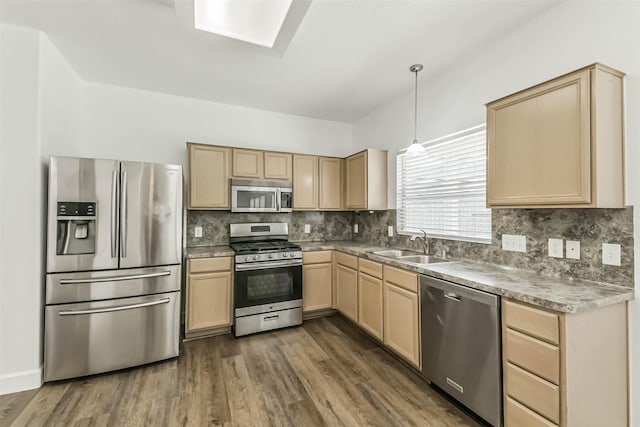 15503 Hickory Dale St, Cypress, TX 77429 - kitchen featuring stainless steel appliances, light brown cabinets, a sink, backsplash, and wood finished floors