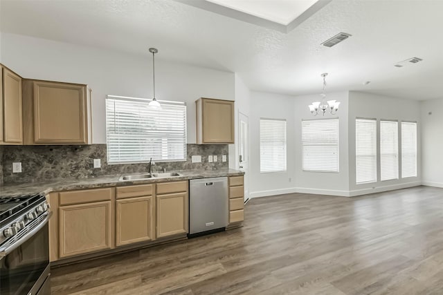 15503 Hickory Dale St, Cypress, TX 77429 - kitchen with appliances with stainless steel finishes, a sink, a chandelier, decorative backsplash, and wood finished floors