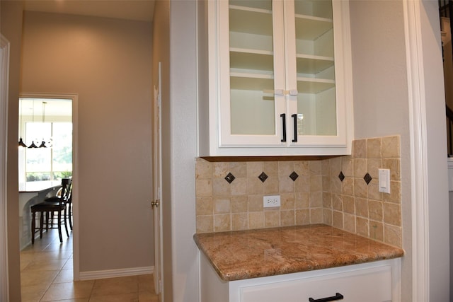 3314 Saint Charles Ct, Missouri City, TX 77459 - bar featuring backsplash, light tile patterned floors, and baseboards