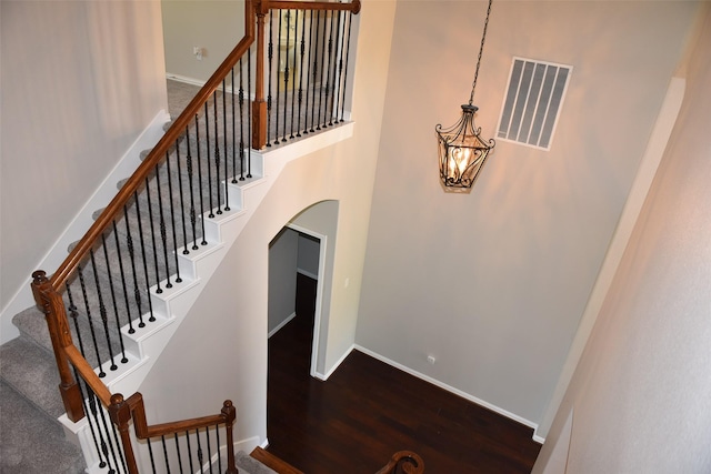 3314 Saint Charles Ct, Missouri City, TX 77459 - stairway with wood finished floors, arched walkways, baseboards, and a towering ceiling
