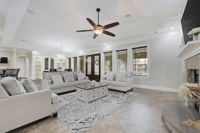 13635 Reeveston Rd, Houston, TX 77039 - living area with ornamental molding, arched walkways, a fireplace, a ceiling fan, and a raised ceiling