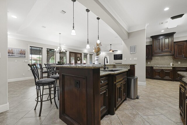 13635 Reeveston Rd, Houston, TX 77039 - kitchen with a sink, crown molding, baseboards, ceiling fan, and backsplash
