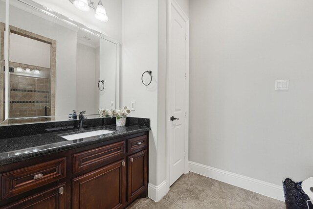 13635 Reeveston Rd, Houston, TX 77039 - bathroom featuring vanity, baseboards, and a tile shower