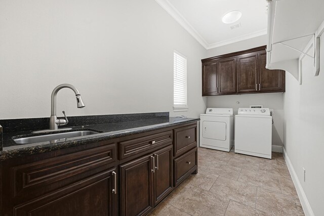 13635 Reeveston Rd, Houston, TX 77039 - laundry area with cabinet space, washer and clothes dryer, ornamental molding, baseboards, and light stone finish floors