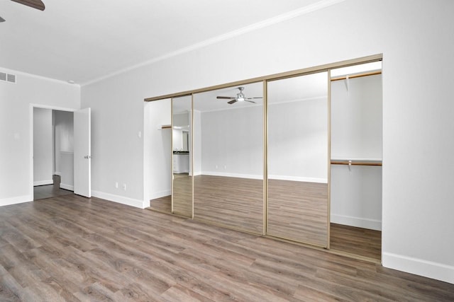 406 Wilcrest Dr Unit 406, Houston, TX 77042 - unfurnished bedroom with ornamental molding, wood finished floors, baseboards, and a closet