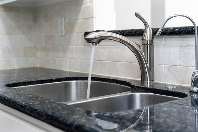 406 Wilcrest Dr Unit 406, Houston, TX 77042 - kitchen view of a sink, dark stone counters, and tasteful backsplash