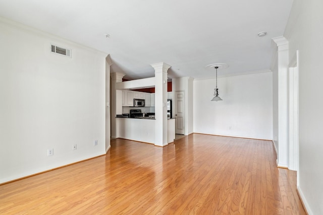 3231 Allen Pkwy Unit 4207, Houston, TX 77019 - unfurnished living room featuring crown molding, light wood-type flooring, ornate columns, and baseboards