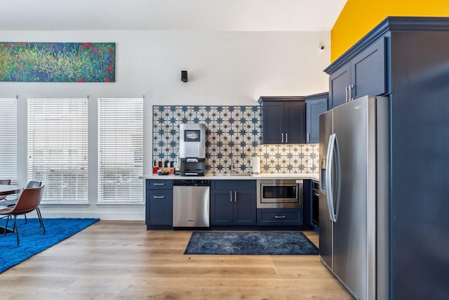 3231 Allen Pkwy Unit 4207, Houston, TX 77019 - kitchen featuring stainless steel appliances, light countertops, decorative backsplash, light wood finished floors, and a sink
