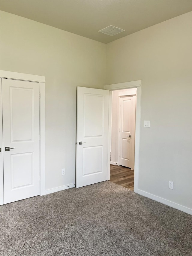 11755 Oakwood Ranch Dr, Willis, TX 77378 - unfurnished bedroom with dark colored carpet and baseboards
