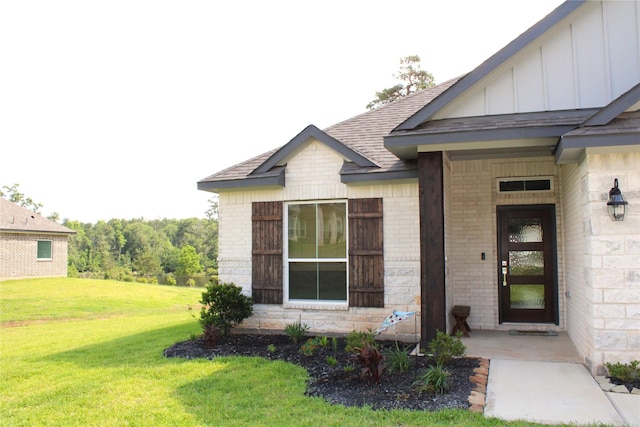 11755 Oakwood Ranch Dr, Willis, TX 77378 - entrance to property featuring board and batten siding, brick siding, a yard, and a shingled roof