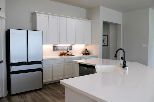 11755 Oakwood Ranch Dr, Willis, TX 77378 - kitchen with a sink, dark wood-style flooring, white cabinets, and stainless steel dishwasher