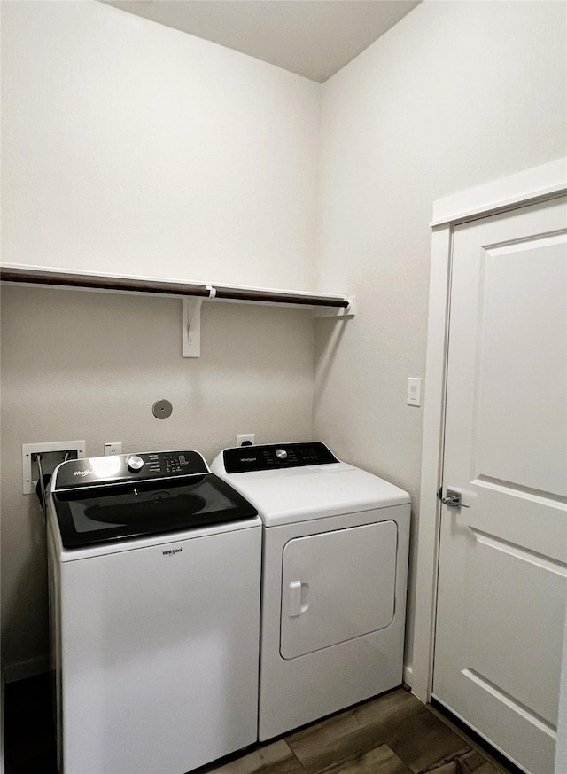 11755 Oakwood Ranch Dr, Willis, TX 77378 - laundry area with washer and clothes dryer and dark wood-type flooring