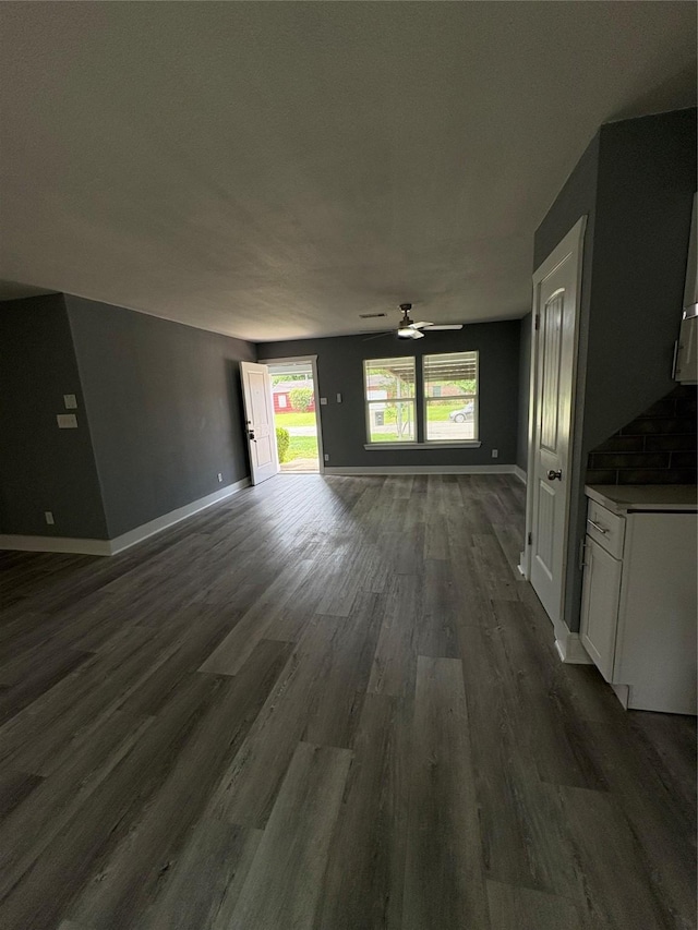 5159 Dumore Dr, Houston, TX 77048 - unfurnished living room featuring dark wood finished floors, ceiling fan, and baseboards