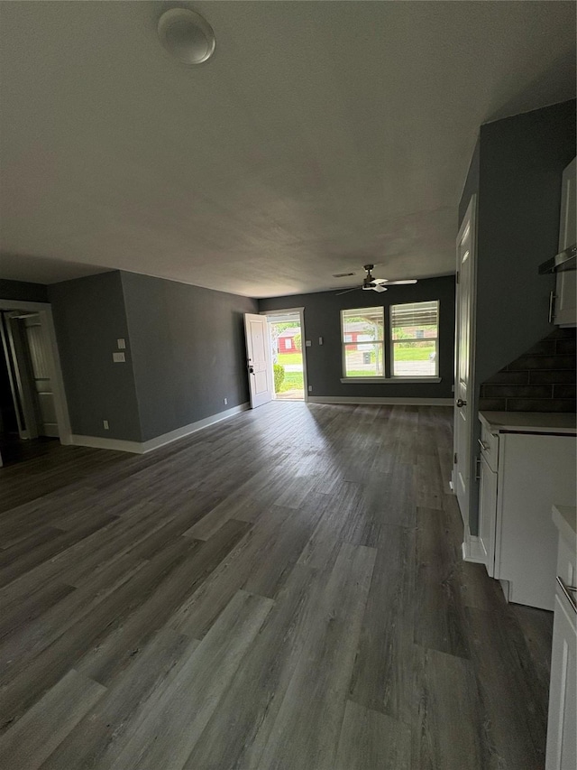 5159 Dumore Dr, Houston, TX 77048 - unfurnished living room with a ceiling fan, dark wood-type flooring, and baseboards