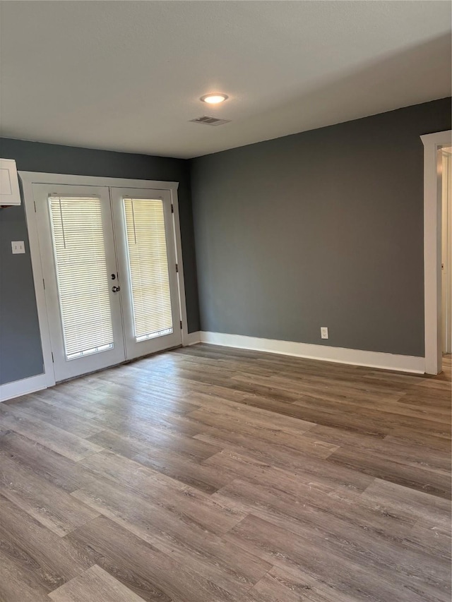 5159 Dumore Dr, Houston, TX 77048 - empty room featuring french doors, wood finished floors, and baseboards