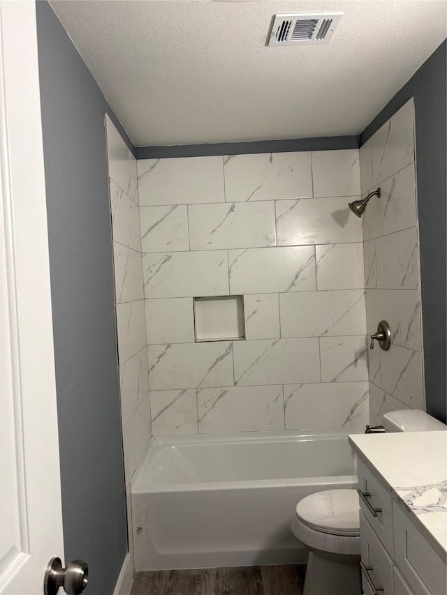 5159 Dumore Dr, Houston, TX 77048 - bathroom with toilet, a textured ceiling, vanity, wood finished floors, and shower / tub combination
