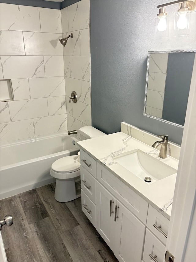 5159 Dumore Dr, Houston, TX 77048 - bathroom featuring vanity, toilet, wood finished floors, shower / tub combination, and a textured wall