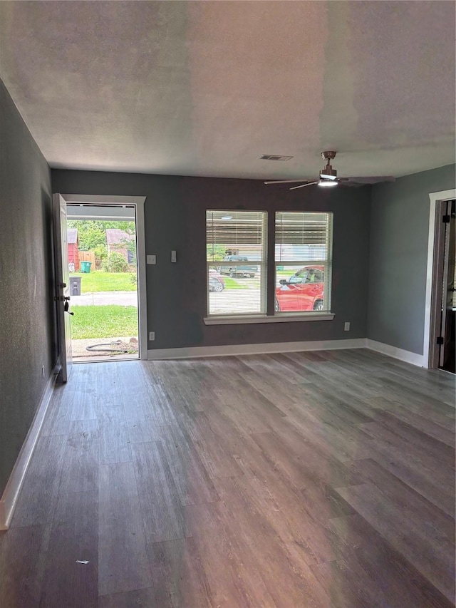 5159 Dumore Dr, Houston, TX 77048 - unfurnished living room with wood finished floors, baseboards, and ceiling fan