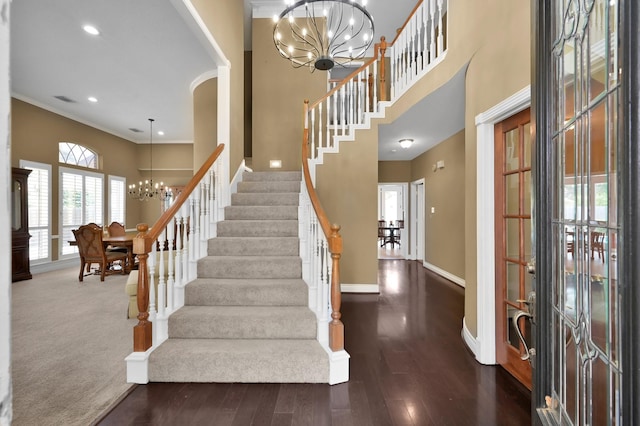 17114 Bur Oak Ct, Spring, TX 77379 - foyer featuring a chandelier, a towering ceiling, stairway, baseboards, and wood finished floors