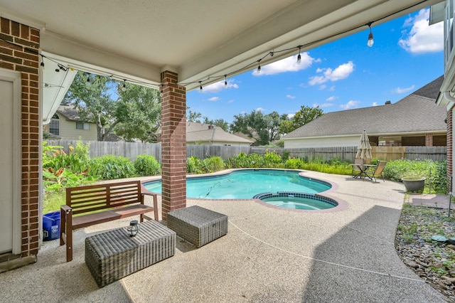 17114 Bur Oak Ct, Spring, TX 77379 - view of swimming pool featuring a patio, a fenced backyard, and a pool with connected hot tub