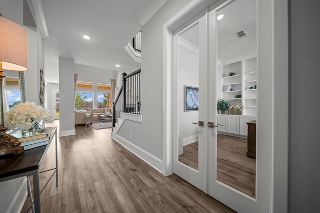 2310 Desert Holly Dr, Katy, TX 77493 - hall with french doors, wood finished floors, stairs, baseboards, and recessed lighting