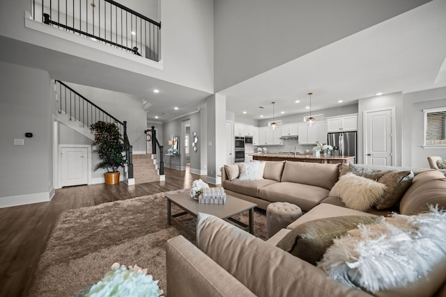 2310 Desert Holly Dr, Katy, TX 77493 - living area with baseboards, stairs, dark wood finished floors, a high ceiling, and recessed lighting