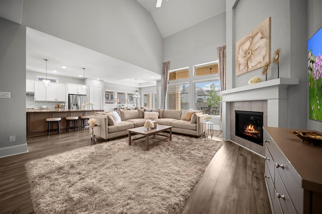 2310 Desert Holly Dr, Katy, TX 77493 - living room with a tiled fireplace, dark wood-type flooring, high vaulted ceiling, and recessed lighting