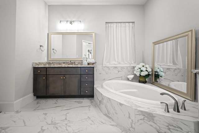 2310 Desert Holly Dr, Katy, TX 77493 - bathroom with vanity, a garden tub, marble finish flooring, and baseboards