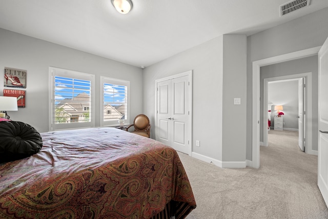 2310 Desert Holly Dr, Katy, TX 77493 - bedroom featuring light carpet, baseboards, and a closet