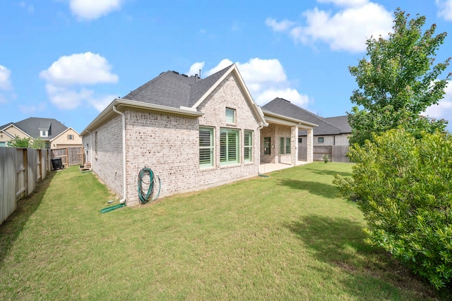 2310 Desert Holly Dr, Katy, TX 77493 - back of property featuring brick siding and a shingled roof