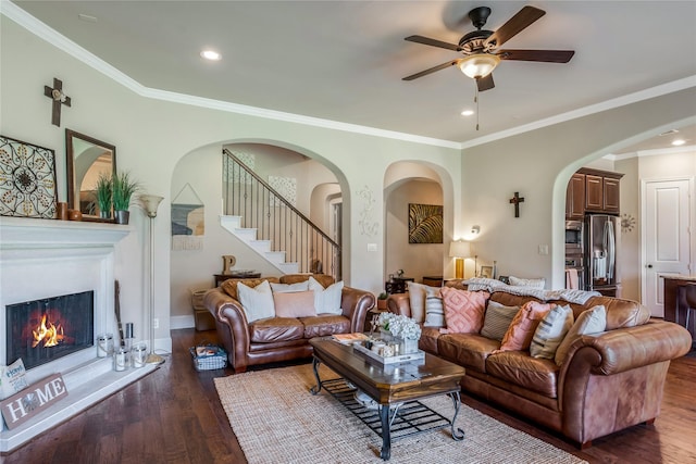 10040 Easton Sky Ln, Cypress, TX 77433 - living area featuring arched walkways, wood finished floors, ceiling fan, stairs, and recessed lighting