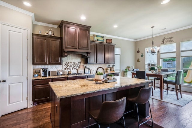 10040 Easton Sky Ln, Cypress, TX 77433 - kitchen featuring a chandelier, light stone countertops, dark wood-style flooring, hanging light fixtures, and tasteful backsplash