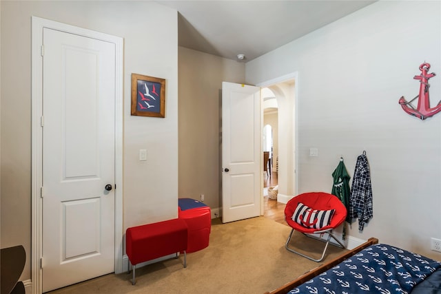 10040 Easton Sky Ln, Cypress, TX 77433 - bedroom with arched walkways, carpet floors, and baseboards