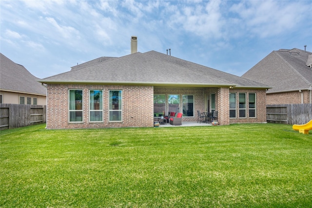 10040 Easton Sky Ln, Cypress, TX 77433 - back of property featuring brick siding, a patio area, a chimney, and roof with shingles