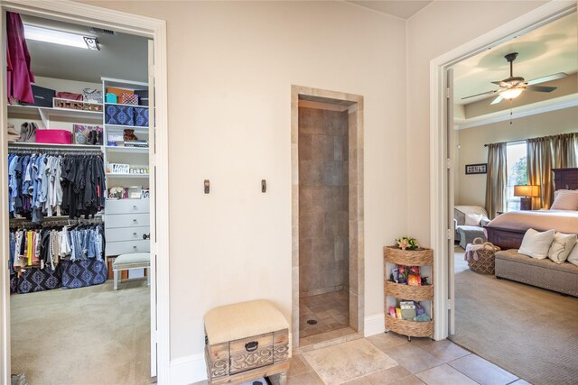 10040 Easton Sky Ln, Cypress, TX 77433 - full bathroom featuring ensuite bath, ceiling fan, tiled shower, tile patterned flooring, and baseboards
