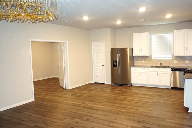 21930 King Heights Ln, Houston, TX 77073 - kitchen featuring appliances with stainless steel finishes, dark wood-type flooring, white cabinets, tasteful backsplash, and baseboards