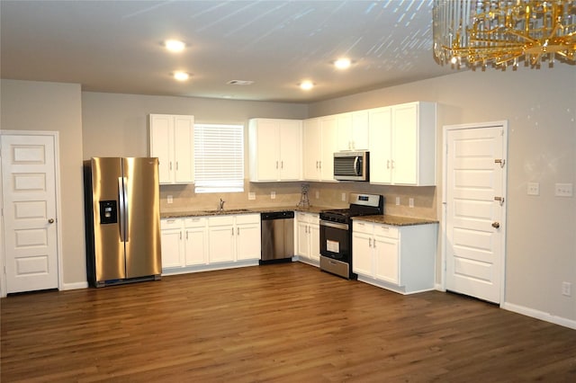21930 King Heights Ln, Houston, TX 77073 - kitchen with stainless steel appliances, dark wood finished floors, backsplash, white cabinets, and recessed lighting