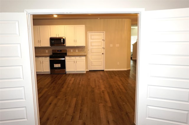 21930 King Heights Ln, Houston, TX 77073 - kitchen with stainless steel appliances, white cabinetry, dark wood finished floors, and decorative backsplash