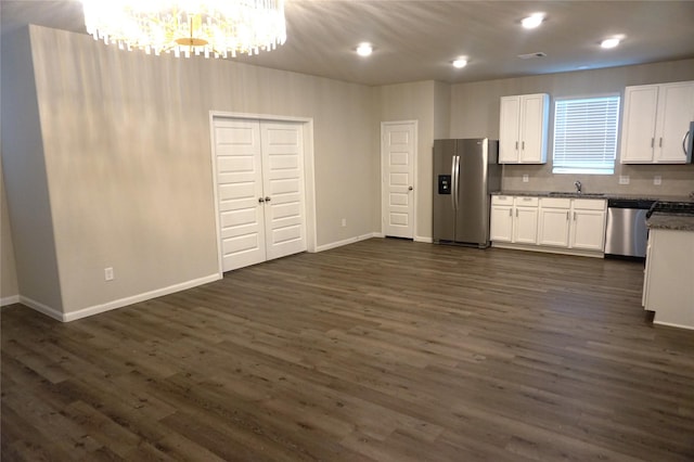 21930 King Heights Ln, Houston, TX 77073 - kitchen featuring appliances with stainless steel finishes, a sink, a chandelier, white cabinets, and recessed lighting