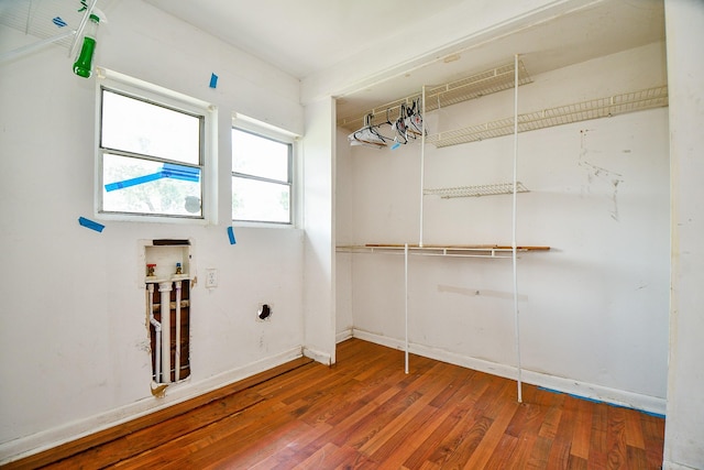 101 Emerald Ct, Houston, TX 77009 - laundry room featuring washer hookup, wood finished floors, and baseboards