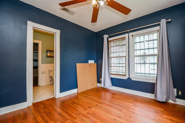 101 Emerald Ct, Houston, TX 77009 - empty room featuring a ceiling fan, wood finished floors, and baseboards